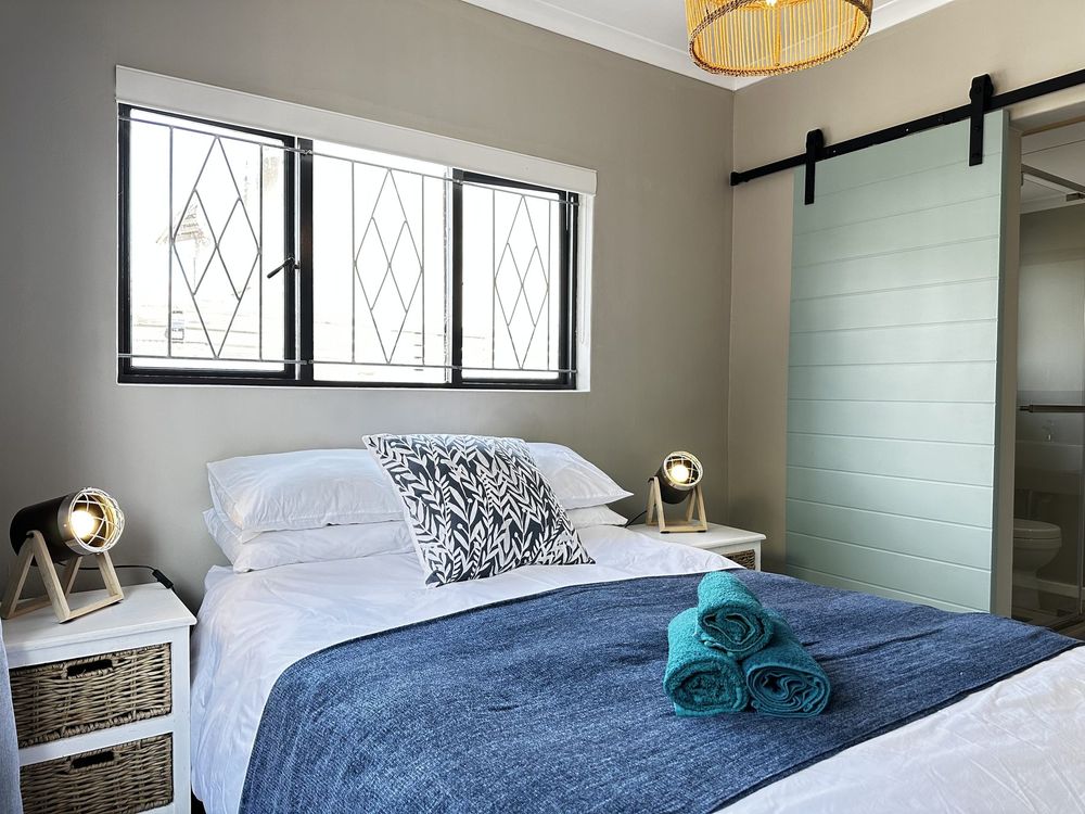 The main bedroom at Kite Cottage, made up with white linen