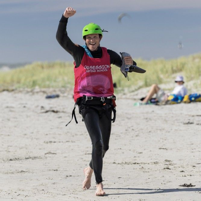 Obsession Kiting student celebrating after a successful kitesurfing lesson